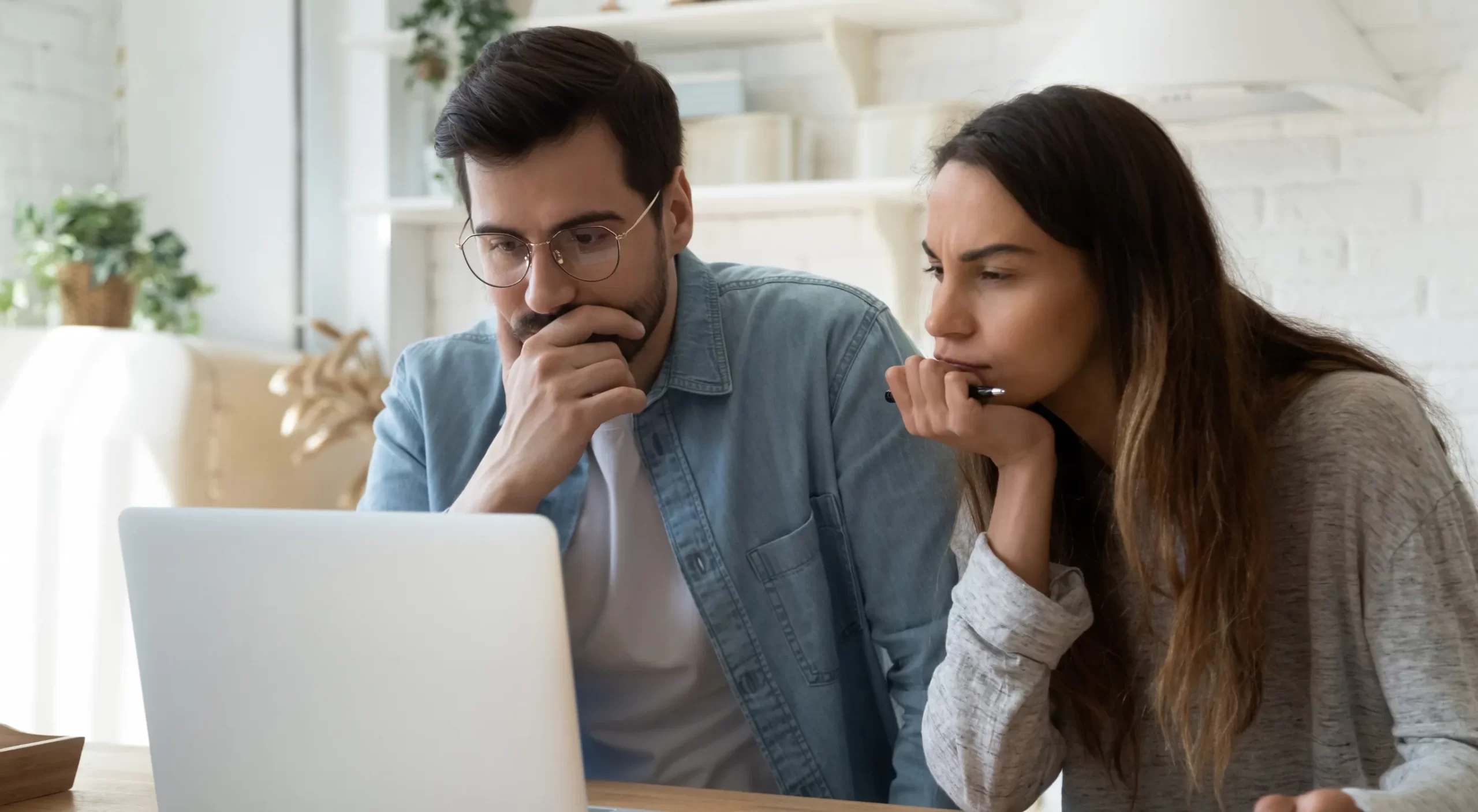 Man and woman thinking about a problem on computer